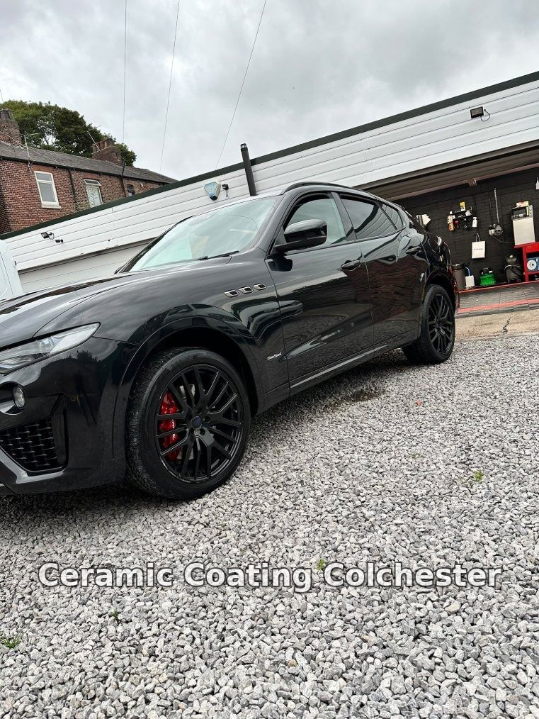 Black Maserati Levante with a high-gloss finish parked outside a detailing workshop